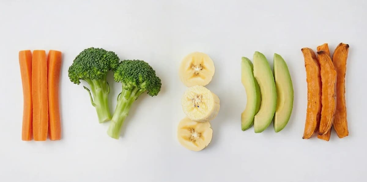 Banana, avocado, carrot sticks, broccoli florets and sweet potato strips — five easy first foods for baby-led weaning